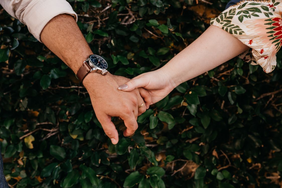 Two people holding hands — a firm that holds its neighbors close