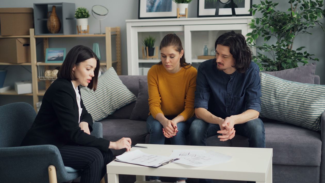 An advisor reviewing a plan with a couple at their table