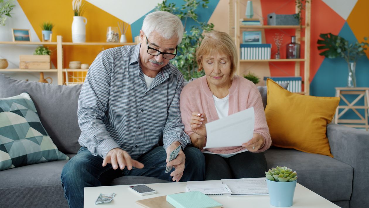 A retired couple at home reviewing their paperwork together