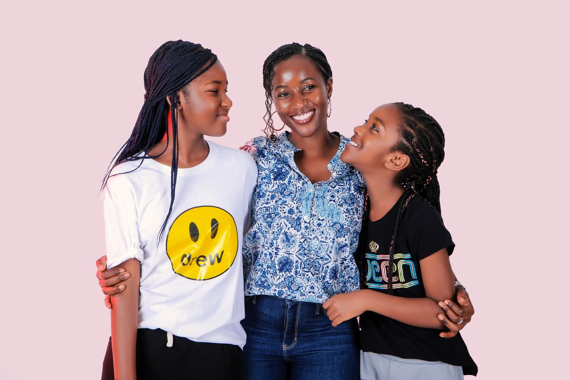 A mother with her two daughters, smiling
